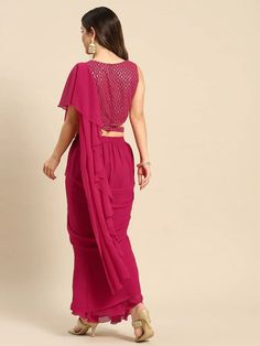 Step out in style with this set from VitansEthnics. Don this look this season for a festive outing with family and friends. Pair it with heels and a clutch to complete the look. Add chunky jewelry like jhumkas and choker accessories. The clothing set consists of one shoulder crop top with a skirt and an attached dupatta. Sizes: To Fit Bust(in inches): S(33), M(35), L(37), XL(39), 2XL(41) To Fit Waist(in inches): S(29), M(31), L(33), XL(35), 2XL(37) Fabric: Georgette Style: Crop Top With Skirt an Frill Gown, Crop Top With Skirt, Chunky Gold Jewelry, Magenta Top, Top With Skirt, One Shoulder Crop Top, Saree Gown, Indo Western Dress, Ready To Wear Saree