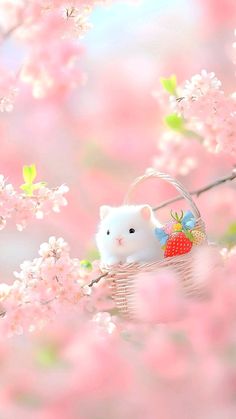 a white hamster sitting in a basket on top of a tree filled with pink flowers