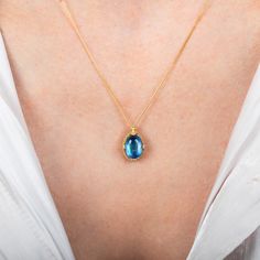 This iridescent Moonstone is formed into the shape of a small oval. We encased it in a handmade gold bezel with braided detail and prongs to showcase its swirling blue beauty. Technical Details Metal: 18k yellow goldMoonstone: 3.18 cts. Pendant Size (not including bail): 12mm x 9mmChain: can be worn at 16" and 18"Closure: lobster claspHandmade in New YorkStyle # N-3471-MO Oval Blue Topaz Yellow Gold Jewelry, Oval Yellow Gold Blue Topaz Jewelry, Gold Jewelry With Gemstone Accents And Oval Cabochon, Elegant Jewelry With Blue Topaz Oval Cabochon, Gold Jewelry With Gemstone Accents, Gold Jewelry With Gemstone Accents In Oval Cabochon, Elegant Blue Topaz Oval Cabochon Jewelry, Blue Topaz Oval Pendant Jewelry, Yellow Gold Necklace With Oval Cabochon Birthstone