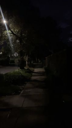 a street light shines brightly in the dark