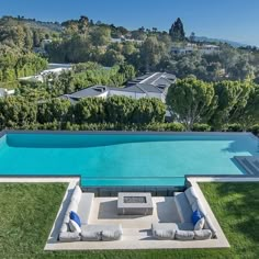 an aerial view of a swimming pool with lounge chairs