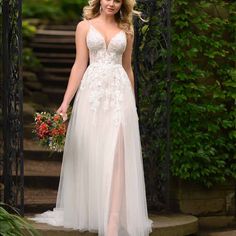 a woman in a wedding dress standing on steps