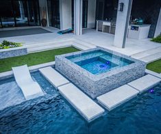 an outdoor swimming pool in the middle of a yard with steps leading up to it