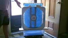 a person standing in front of a door with an air conditioner on top of it