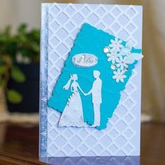 a blue and white wedding card with an image of a bride and groom holding hands