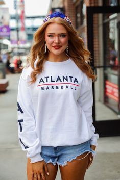 Calling all Braves fans, the White Atlanta Baseball Sweatshirt was made just for you! This comfy sweatshirt is designed with a soft and stretchy knit with a fleece interior. It features a crew neckline, long sleeves with "ATL" down them, a relaxed fit, and the words "Atlanta Baseball" on the front. Style the White Atlanta Baseball Sweatshirt with your favorite denim and a baseball hat for a cute game day look! Jerzees Brand Soft + Stretchy Knit Fabrication Fleece Interior "Atlanta Baseball" Grap Cute Game, Baseball Sweatshirts, Cute Games, Comfy Sweatshirt, Baseball Hat, Large Bust, White Sweatshirt, Small Bust, Game Day