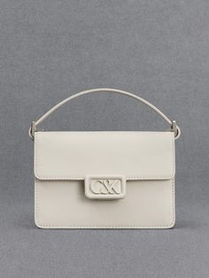 A polished and pristine all-white leather bag is an investment-worthy piece that deserves a spot in your capsule wardrobe - our boxy bag is a case in point. Made with genuine calf leather, this bag feels as luxurious as it looks. It opens up to a roomy main compartment that can hold your essentials and then some. The matching white hardware is polished and striking. Fitted with a thick shoulder strap that is also made with soft and supple leather, it will hang comfortably on your shoulder. Chic Rectangular Box Bag With Branded Hardware, Luxury White Box Bag With Top Handle, Modern Box Bag With Branded Hardware For Office, Luxury White Box Bag With Detachable Handle, Luxury White Leather Box Bag, Designer White Rectangular Case Bag, Luxury White Rectangular Case Bag, Modern Office Box Bag With Branded Hardware, Luxury White Box Bag With Top Carry Handle