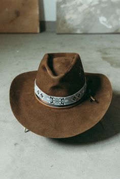 Western 100x in Whiskey with custom distressing and hand shaping 3 1/2" brim Elk leather accent band Hand stitched Mountain detail West hat band sold separately. This felt hat is made to order, please allow 6-8 weeks for delivery. Western Felt Hats, Custom Brown Hat Bands For Festival, Leather Fedora With Flat Crown In Country Style, Fitted Leather Hats For Western-themed Events, Distressed Brown Adjustable Short Brim Hat, Country Style Fedora For Western-themed Events, Rustic Brown Top Hat With Curved Brim, Rustic Brown Brimmed Top Hat, Custom Brown Fedora With Flat Brim