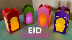 four colorful paper lanterns sitting on top of a green table with the words, eid lanterners