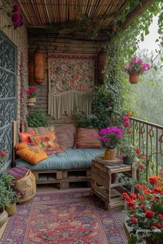 a porch with lots of flowers and plants on it