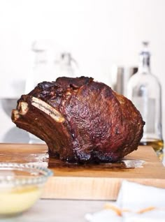 a large piece of meat sitting on top of a wooden cutting board