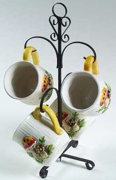 two coffee cups with bananas on them are sitting on a stand that is attached to a cup holder