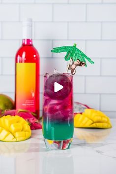 a colorful cocktail with pineapple, raspberry and lime