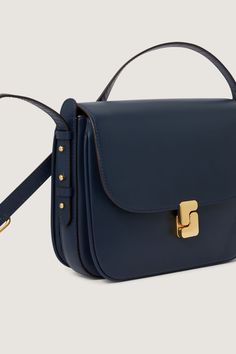 Prussian blue glazed leather bag - Shoulder, or cross-body bag - Adjustable leather handle, maximum length 135 cm - Large front flap with golden monogrammed clasp - One zipped inside pocket - Golden metal details - Height 19 cm, width 24 cm, depth 5 cm Timeless Blue Shoulder Bag For Evening, Luxury Navy Shoulder Bag With Gold-tone Hardware, Navy Bags With Detachable Strap For Formal Occasions, Timeless Blue Bag With Top Handle, Classic Satchel Flap Bag With Adjustable Handle, Navy Leather Shoulder Bag With Gold-tone Hardware, Blue Business Satchel, Luxury Blue Flap Bag With Gold-tone Hardware, Classic Blue Crossbody Flap Bag