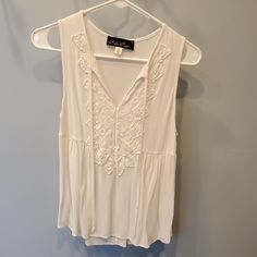 Sleeveless White Top Lightweight Cotton Never Worn Sleeveless Embroidered Spring Vest, Spring Sleeveless Embroidered Vest, Sleeveless Embroidered Vest For Spring, Spring Embroidered Sleeveless Vest, Embroidered Sleeveless Vest For Spring, Casual Embroidered Sleeveless Vest, Summer Sleeveless Embroidered Vest, White Sleeveless Embroidered Top For Summer, Sleeveless Embroidered Floral Top For Spring