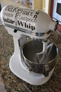 a white mixer sitting on top of a kitchen counter