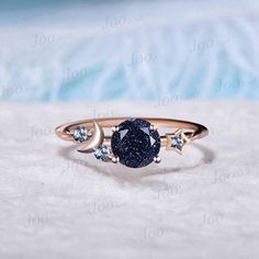 I LOVE YOU TO THE MOON BACK RING 1ct Round Cut Galaxy Starry Night Blue Goldstone Ring Cluster Alexandrite Wedding Ring Moon Star Design Unique Promise Ring Birthday Gifts Accept engrave the words inside the ring service: https://www.etsy.com/listing/1103764936/engrave-service HEALING RING : Blue Sandstone (also known as Blue Goldstone) symbolizes enterprise, success, victory, and glory, which enhance one's leadership and entrepreneurial skills. It is an excellent stone to meditate with before giving a speech or starting a new project. It is also very good at calming the senses and cleansing the chakras on all levels. Blue Sandstone bridges the gap between the earthly and spirit realms, so it is a great stone to use for contacting spirit guides or performing holistic healing. Blue Sandston Blue And Black Ring, Night Sky Jewelry, Space Themed Engagement Ring, Moon Promise Ring, Starry Engagement Ring, Galaxy Ring Engagement, Moon Ring Design, Starry Night Ring, Celestial Sapphire Anniversary Rings