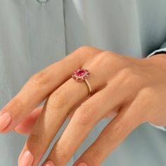 Celebrate your femininity with this gorgeous Ruby Floral Ring. This beautiful flower ring portrays elegance and charm. Crafted in the perfect sheen of 14k solid gold. - Made in 14k solid gold - Decorated with handset ruby coloured cubic zirconia stone on 14k solid gold - Band Width: 1.75 mm / 0.068 inches - Top Width: 13.45x11.40 mm / 0.529x0.448 inches - Thickness: 1.00 mm / 0.039 inches -This product comes with iconic Norm Jewels gift box Elegant Diamond Flower Ring For Proposal, Elegant Ruby Wedding Ring With Halo, Elegant Ruby Rings With Halo, Delicate Oval Ring With Halo Setting, Yellow Gold Halo Ruby Ring For Wedding, Elegant White Gold Flower Ring For Proposal, Elegant Formal Ruby Halo Ring, Delicate Yellow Gold Diamond Ring With Gemstone, Elegant Flower Ring With Prong Setting For Proposal