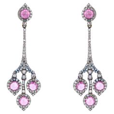 Immerse yourself in elegance with our 4.24 Carat Diamond and Pink Sapphire Drop Earrings, where exquisite craftsmanship meets the enchanting allure of precious gemstones. Each pair is meticulously curated to embody sophistication and luxury, crafted to elevate your style with grace and charm. These earrings feature a total of 2.12 carats of stunning pink sapphires, selected for their delicate hue and exceptional clarity. Each sapphire is expertly cut to enhance its natural beauty and brilliance, surrounded by 2.12 carats of dazzling diamonds. The diamonds, meticulously arranged in a drop setting, add a touch of sparkle and sophistication, ensuring these earrings catch and reflect light with every movement. The drop design of the earrings lends them a graceful silhouette, enhancing the wear Sapphire Drop Earrings, Drop Design, Sparkly Things, Drops Design, Magpie, Precious Gemstones, Pretty Pink, Pink Sapphire, Luxury Jewelry