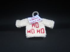 a knitted sweater ornament with a tag on it that says oh no