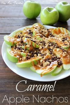 apples with nuts and caramel sauce on a white plate next to some green apples