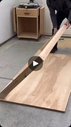 a man is working on a piece of wood