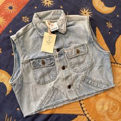 Uo Renewal Raw Cropped Denim Vest Size M/L Brand Is “Guess Jeans” As Shown On The Front Of The Vest. Nwt Unique Vintage Piece Updated With A Raw Cut Hem. This Modern Design Was Created By Urban Renewal From Unique Vintage And Deadstock Items Found Around The World. Casual Cotton Denim Vest With Frayed Hem, Casual Denim Vest With Frayed Hem, Cropped Medium Wash Denim Vest For Fall, Trendy Light Wash Denim Vest With Buttons, Trendy Light Wash Cotton Denim Vest, Medium Wash Denim Cutoff Tops, Light Wash Cotton Denim Vest With Frayed Hem, Medium Wash Cotton Cutoff Tops, Light Wash Denim Vest With Frayed Hem