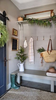 the entryway is decorated with greenery and hanging hooks