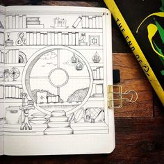 a notebook with a drawing on it next to a yellow pencil and some bookshelves