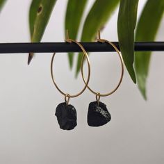 ✨ Golden, waterproof stainless steel hoop earrings with small, raw black tourmalines. ✨ Each tourmaline is lovingly handcrafted into a pendant and finally a high-quality creole. The size of the gemstones varies between 8-10 mm. Since these are natural stones, no two crystals are the same, each one is unique. ♥ The diameter of the hoop earrings is 2 cm. The hoop earrings are simply hooked together for easy opening and closing. 2 pieces per sale. ☼ To charge your crystal it can be placed in sunlig Black Tourmaline Jewelry, Golden Hoop Earrings, Raw Black Tourmaline, Golden Hoops, Tourmaline Earrings, Tourmaline Jewelry, Crystal Hoop Earrings, Jewelry Crystal, Earrings Black