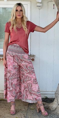 Comfy Wide-Leg Pant with a Ruched Elastic Waistband for a Custom Fit. Features a Stylish Paisley Print. 100% Viscose Model is 5'8 One Size Made in Italy Bohemian High Waist Pants With Elastic Waistband, Bohemian High Waist Bottoms With Elastic Waistband, Pink Bohemian Wide Leg Pants With Elastic Waistband, Bohemian Pink Pants With Elastic Waistband, Casual Pink Harem Bottoms, Bohemian Ankle-length Bottoms With Elastic Waistband, Bohemian Long Pants With Elastic Waistband, Bohemian Stretch Rayon Bottoms, Bohemian Wide-leg Pants With Elastic Waistband