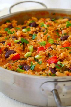 a pan filled with rice and beans on top of a table