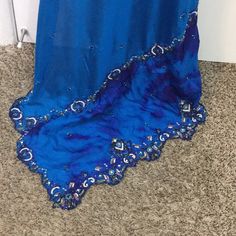 Indian Royal Blue Wedding Saree- Beautiful Royal Blue Color - Silk Material - Blouse Included - Contrast Color Beads And Stone Work On The Edges And All Over The Saree- Blouse Shoulder 14 Inches Armpit To Armpit 37 Waist 29 Inches Neck Deep To 5 Inches Saree Over All Length 6 Yards Belted To The Last End Is 29 Length From Waist To Toe 39.5 Inches Traditional Blue Embellished Gown, Traditional Embellished Blue Gown, Elegant Royal Blue Party Dupatta, Traditional Blue Gown With Traditional Drape, Traditional Blue Gown With Drape, Formal Blue Floor-length Lehenga, Traditional Blue Gown For Wedding, Blue Floor-length Saree With Pallu, Royal Blue Saree With Dupatta For Party