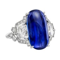 Burmese sapphire and diamond ring, centering on an elongated oval-shaped cabochon-cut sapphire weighing 10.81 carats, in a fancy platinum mounting set with two larger shield-cut diamonds weighing 1.69 total carats and smaller kite-shaped, baguette-cut and round-cut diamond accents weighing 0.54 total carats. Designed by Raymond C. Yard. Circa 2014 Elongated Oval, Colored Diamond Rings, Sapphire And Diamond Ring, Sapphire Rings, Sapphire Diamond Ring, Sapphire Jewelry, Baguette Cut, Blue Rings