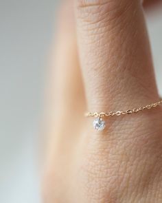 14k Gold chain with beautiful diamond in a drilled jump ring setting.This gorgeous minimalist diamond solitaire ring features a .1ct round brilliant diamond on a dainty chain as if the diamond was naked.Diamond is Genuine and Conflict Free10 point diamond weighs 0.1 ct.,about 3mm. SI1 clarity and H-I color. Dainty Round Cut Diamond White Jewelry, Dainty Diamond White Round Cut Jewelry, Delicate Diamond White Jewelry With Single Diamond, Dainty Single Diamond Jewelry In Diamond White, Delicate Single Diamond White Jewelry, Dainty Single Diamond White Jewelry, Dainty White Jewelry With Single Diamond, Delicate White Jewelry With Single Diamond, 14k Gold Jewelry With Single Diamond In Diamond White