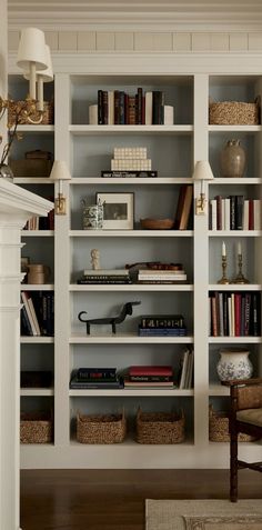 a white bookcase filled with lots of books