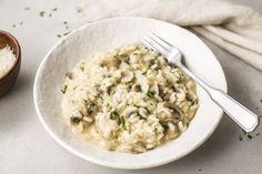 a white bowl filled with rice and mushrooms