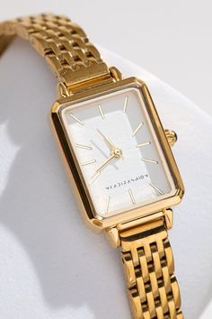 Elevate your style with the Mila 18K Gold Watch. The Mila 18K Gold Watch combines minimalist design with timeless elegance, perfect for any outfit or occasion. It's sleek design expertly combines its lightweight, comfortable feel, and a polished 18K gold finish making it ideal for everyday wear or special occasions. The Mila 18K Gold Watch is made with premium quality stainless steel and expertly coated with polished 18K gold that gives it a refined look that radiates modern sophistication. This Classic Gold Watch Women, Elegant Gold Watch, Timeless Watches Women, Women’s Gold Watch, Old Money Watches Women, Designer Watches Women, Women Gold Watch, Luxury Watches Women, Dainty Gold Watch