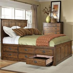 a bed with drawers underneath it in a bedroom