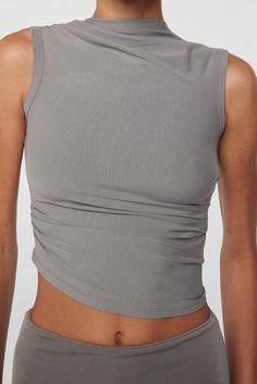 Sleeveless Stretch Tops With Ruched Back, Chic Stretch Tank Top With Ruched Back, Fitted Casual Top With Ruched Back, Fitted Ruched Cami Tank Top, Sleeveless Summer Tops With Ruched Back, Casual Fitted Top With Ruched Back, Sleeveless Top With Ruched Back, Fitted Ruched Top With Tank Straps, Fitted Modal Camisole Tank Top