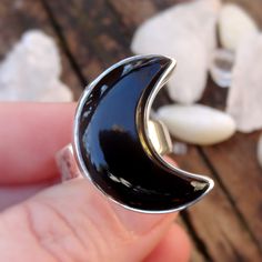 "☾Handmade, Natural Black Onyx Sterling Silver Moon Statement Rings☾ ❤︎Featured in this listing is a sterling silver, handmade, natural stone ring. This lovely ring features a beautiful, Natural Black Onyx Large Moon shaped stone. The Black Onyx Moon has been bezel set into a highly polished, Sterling Silver, sturdy setting. ❤︎Wide gradual band from 4-6mm ❤︎These large 1\" Moons in black onyx have been highly polished, with a rise of 7mm ❤︎Each ring has been hand made, so may vary slightly Stone Mystical Black Ring As Gift, Black Mystical Ring Jewelry, Mystical Black Ring Jewelry, Black Mystical Style Jewelry Ring, Mystical Black Sterling Silver Rings, Black Adjustable Crescent Jewelry, Unique Black Jewelry With Moon Phase, Black Crescent Celestial Jewelry, Unique Black Moon Phase Jewelry