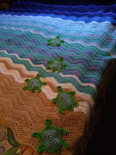 a crocheted blanket with sea turtles on it