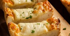 several slices of bread with cheese and parsley on top