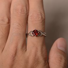 This is a gorgeous handmade creation. Its beauty is its simplicity & Elegance. The 6*6 mm round shape faceted natural Garnet is crafted in solid sterling silver and with rhodium plated. All item is sent in a beautiful gift box If you have any idea of design your ring,pls contact me directly. You can realize more lovely stuff clicking the link https://www.etsy.com/shop/knightjewelry?refshopsection_shophome_leftnav Please leave the correct address and you phone number for delivering successful Red Birthstone Promise Ring With Round Band, Ruby Birthstone Ring For Promise, Red Solitaire Birthstone Promise Ring, Adjustable Red Birthstone Promise Ring, Red Round Stone Promise Ring, Garnet Ruby Ring For Promise, Red Birthstone Ring With Round Band, Elegant Faceted Ruby Promise Ring, Red Birthstone Ring With Round Stone For Gift