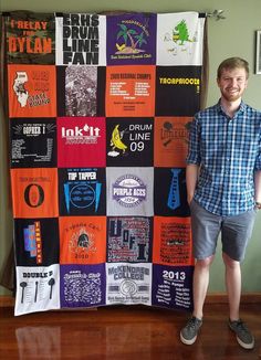 a man standing in front of a quilt made with t - shirts