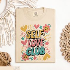 Embrace positivity with our Self Love Club T Shirt. This inspirational graphic tee promotes self-care and positive affirmation. Perfect for those who value self-love and want to spread positivity. The retro style design makes it a unique addition to your wardrobe. Whether you're treating yourself or looking for a thoughtful gift, this cute self-care top is an excellent choice. Get yours now and join the Self Love Club! 🌎 Comfort Colors 1717 Shirt | Timeless Style & Comfort Discover the essence of classic comfort with our Comfort Colors 1717 Unisex Garment-Dyed Heavyweight T-Shirt. A perfect blend of traditional style, modern durability, and eco-friendly craftsmanship. 🧵 Material & Quality: Made from 100% ring-spun cotton, this 6.1 oz/yd² (206.8 g/m²) shirt is pre-shrunk and garment-dyed Cute Self Care, Inspirational Graphic Tees, Self Love Club, Boho Shirt, Club T Shirt, Retro Mode, Boho Shirts, Love Club, Conscious Fashion