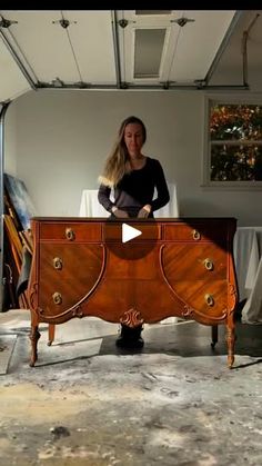 a woman sitting at a desk in front of a mirror with her hand on top of it