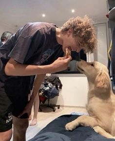 a man is feeding his dog some food