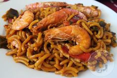 a plate with noodles and shrimp on it