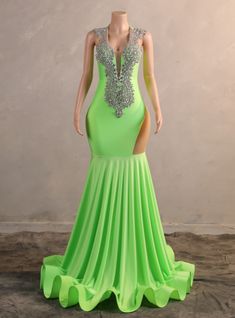 Rock the night away in this dazzling neon green prom dress, designed to turn heads and make a lasting impression. The gown boasts a plunging neckline adorned with elaborate silver beadwork, adding a touch of elegance and sophistication. The fitted silhouette hugs your curves, highlighting your figure, while the high side slit offers a daring glimpse of leg. The mermaid-style skirt flows seamlessly into a dramatic sweep train, ensuring you move with grace and poise. This dress is perfect for those who wish to make a bold and unforgettable statement at their prom or any formal occasion. The vibrant color combined with the intricate detailing makes this gown a standout choice. Step into this dress and experience the magic of a night filled with elegance and charm, leaving everyone in awe of y Neon Green Prom Dress, Red Velvet Prom Dress, Champagne Homecoming Dresses, Short Sleeve Prom Dresses, Black Mermaid Prom Dress, Crystal Prom Dress, Haute Couture Wedding Dress, Velvet Prom Dress, Green Mermaid